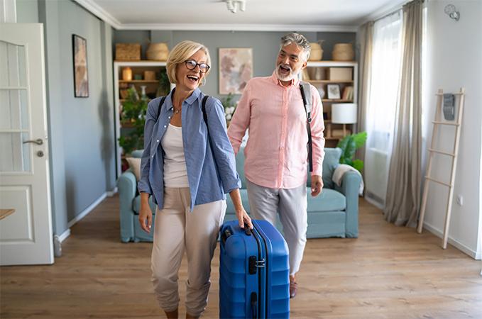 Two people traveling with luggage.